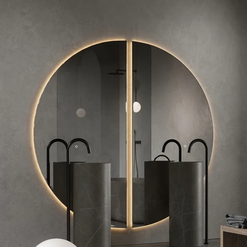 Elegance Luxury Half Moon Glow mirror with warm backlighting, mounted on a beige wall above a matching minimalist console table.