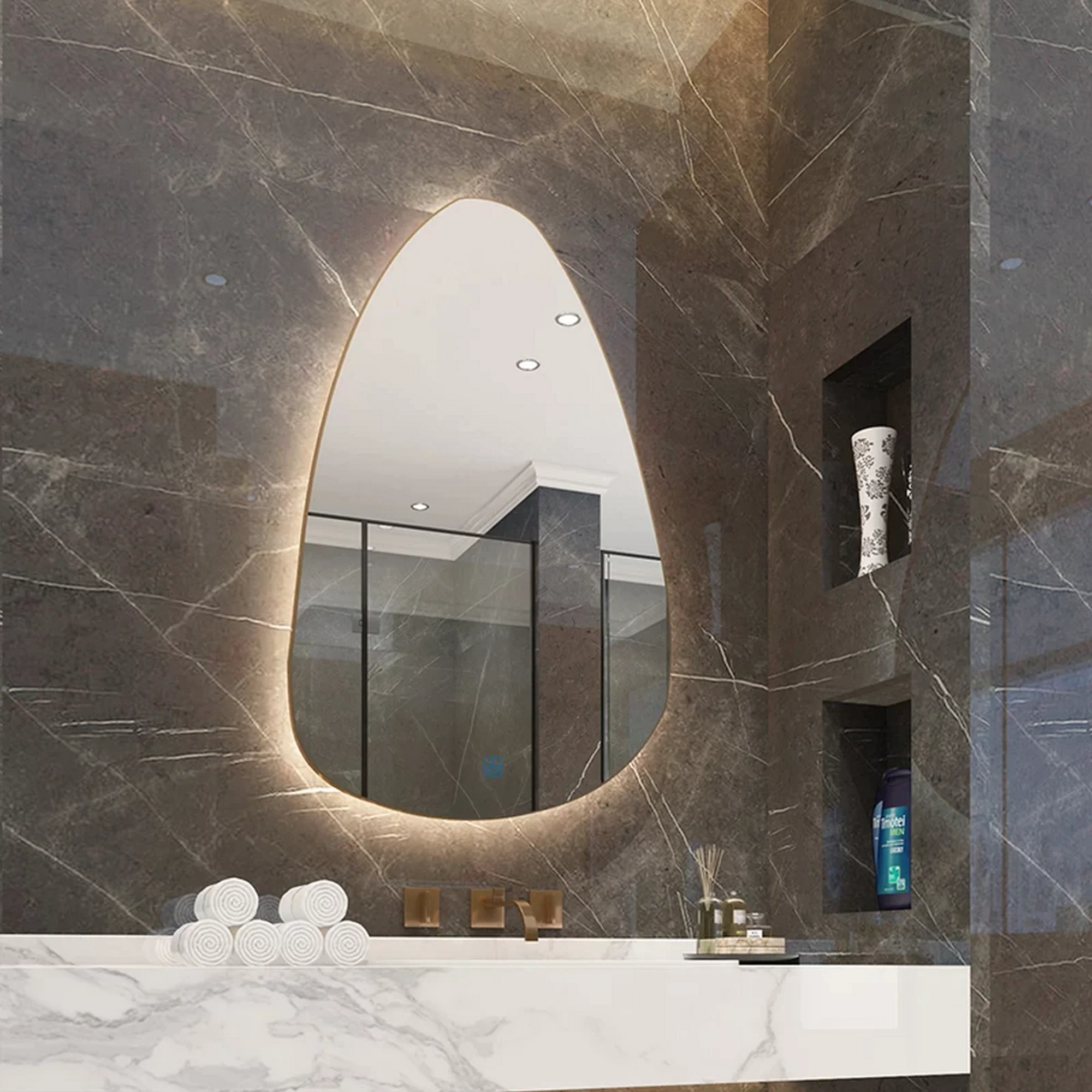 Soft Oval Organic Mirrors for Refined Vanity Spaces, backlit asymmetrical mirror on marble wall above modern vanity with warm lighting