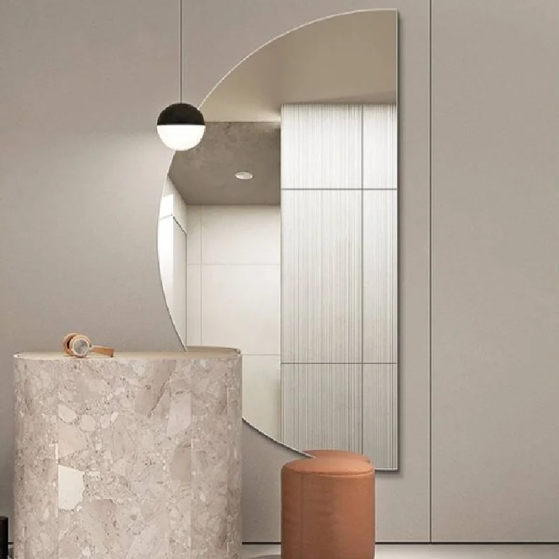 Elegance Luxury Half Moon Glow mirror with warm backlighting, mounted on a dark grey wall above a black countertop and gold tap.