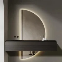 Elegance Luxury Half Moon Glow mirror featuring a vertical backlit semi-circle design behind a dark floating bathroom vanity.