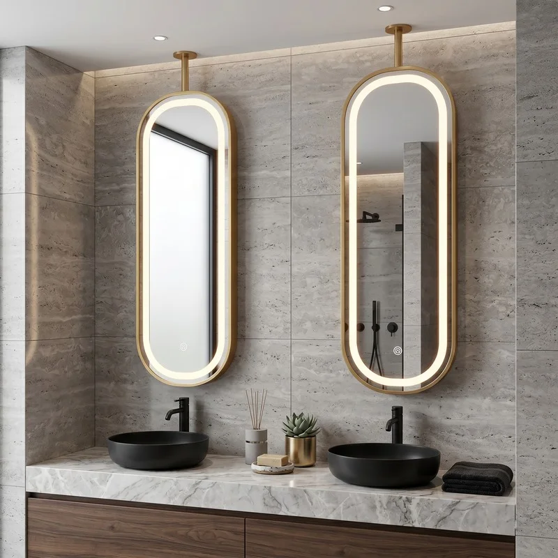 Twin oval backlit mirrors above a marble bathroom vanity with two black vessel sinks.