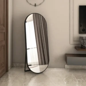 Luxury Full-Length Oval Floor Mirror with sleek black frame placed in a modern living room corner near wall paneling and window curtains