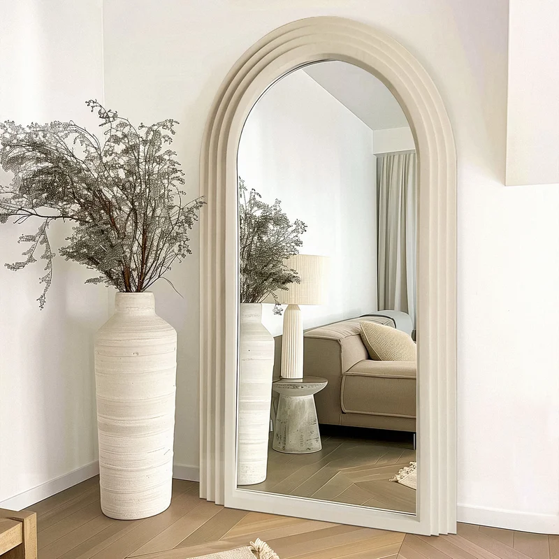 Creative Arch Full Length Floor Mirror with layered frame reflecting a cozy living space, sofa, lamp, and neutral decor.