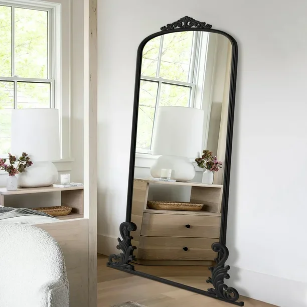 Luxury Victorian Framed Full-Length Floor Mirror in elegant black frame placed in a bright bedroom corner beside a wooden dresser and window