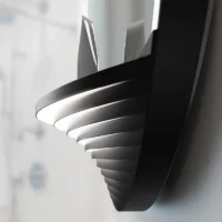 Close-up of the LED Half Moon Round Black Frame Mirror's bottom shelf, showing a layered, ribbed design with integrated lighting.