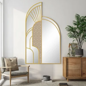 Creative Hollywood Screen Floor Mirror with gold geometric frame in a modern living room beside wooden furniture and plants