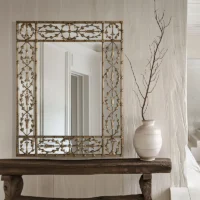 floral metallic framed rectangular mirror placed on a table