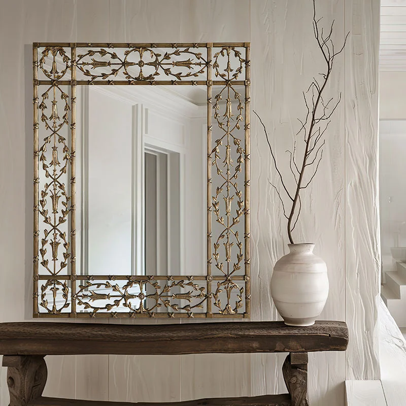 floral metallic framed rectangular mirror placed on a table