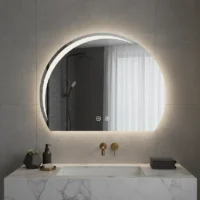 Luxury Half LED Moon Circle Mirror with soft backlit glow above marble sink, modern bathroom vanity with gold faucet and minimalist decor.