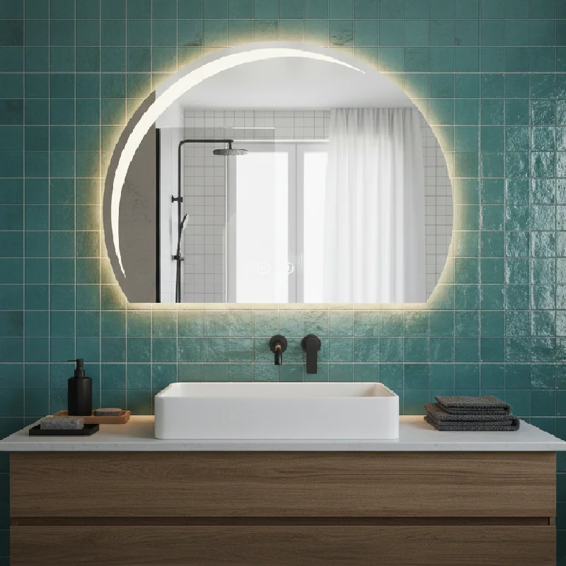 Luxury Half LED Moon Circle Mirror with warm backlit glow above modern vanity and sink, set against glossy teal tile bathroom wall.