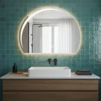 Luxury Half LED Moon Circle Mirror, a backlit crescent mirror mounted on a teal tiled wall above a wood and marble vanity.