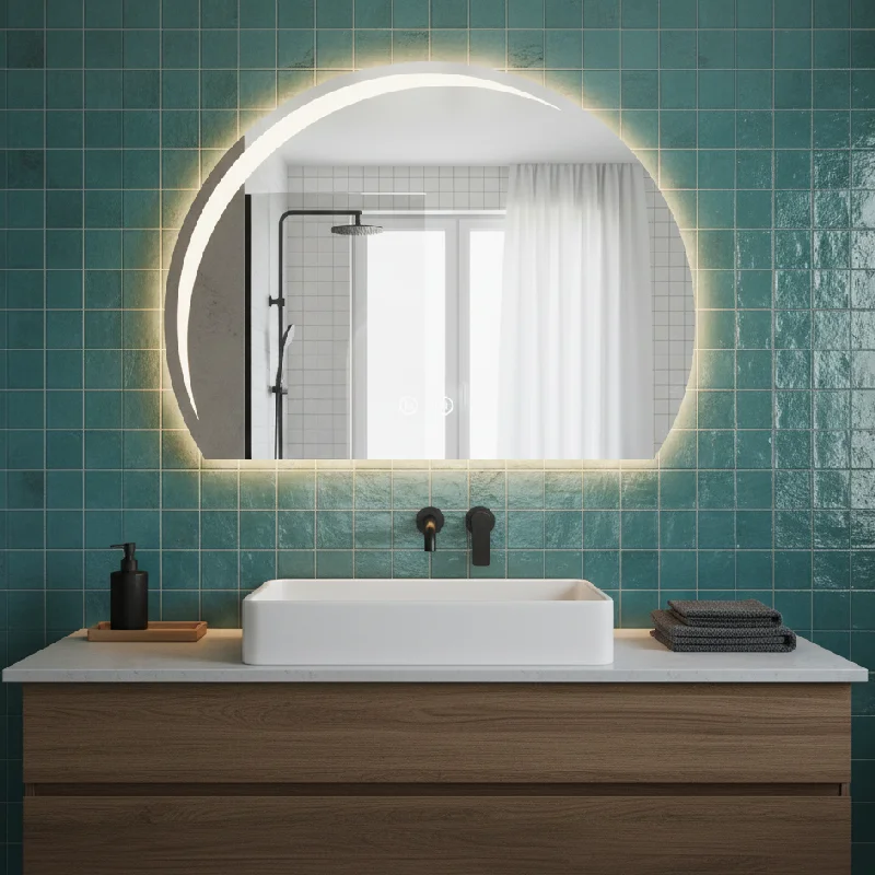Luxury Half LED Moon Circle Mirror, a backlit crescent mirror mounted on a teal tiled wall above a wood and marble vanity.