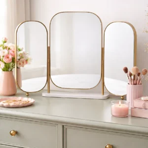 Gold Triple Dressing Foldable Table Mirror with three rounded panels and a white base on a vanity.