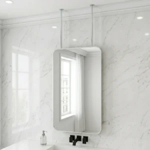 Wall-mounted rounded bathroom mirror hanging from ceiling rods above a marble wall and a white sink with a black faucet and soap dispenser