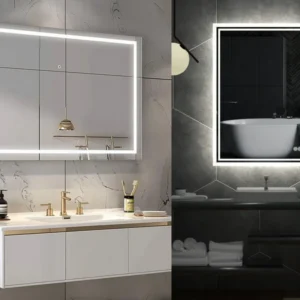 1-99880 - Mi-Mirror Two modern bathrooms with backlit mirrors: bright marble-left vanity and dark tile-right vanity.
