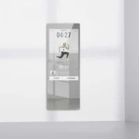 Wall-mounted smart fitness mirror showing a person doing a lunge exercise with a 4:27 timer on screen.