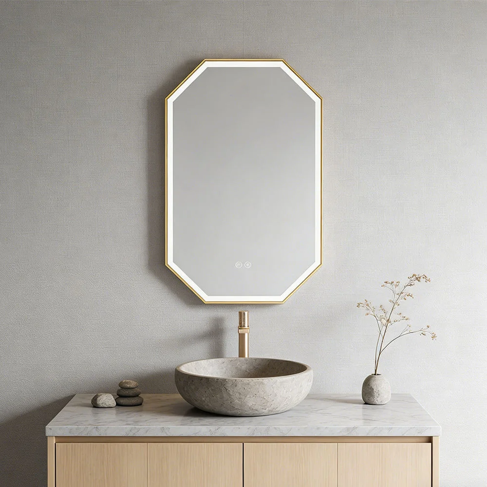 Geometric octagonal mirror with a gold frame above a marble countertop sink on a light wood vanity in a minimalist bathroom.