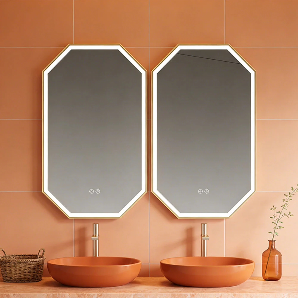 Two octagonal framed mirrors above matching orange vessel sinks on a peach tile wall.