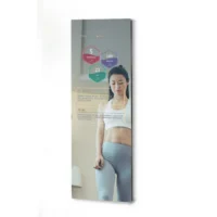 Woman in white sports bra and gray leggings with colorful hexagonal data overlays (fitness HUD) projected in front of her.