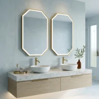 Modern bathroom vanity with double oval sinks, gold faucets, and two octagonal-framed mirrors above a marble countertop.