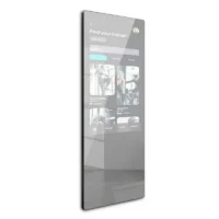 Tall vertical touchscreen panel showing a fitness-trainer finder interface with a search bar and grid of trainer cards, reflected on a glossy surface.