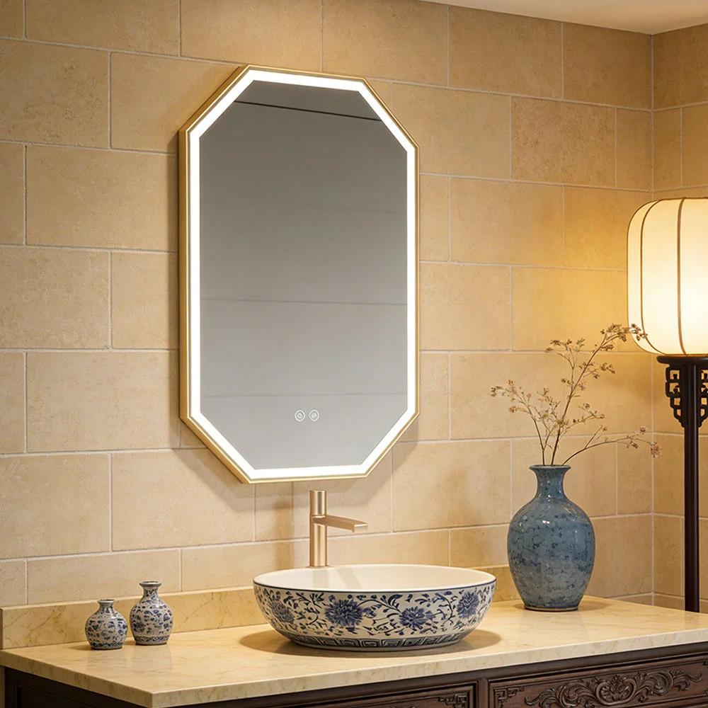 Backlit octagonal mirror over a blue floral ceramic sink on a marble countertop with beige tile wall and a blue vase next to a lamp.