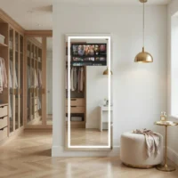 Full-length backlit vanity mirror in a bright walk-in closet with glass-front wardrobes and wooden floors nearby.